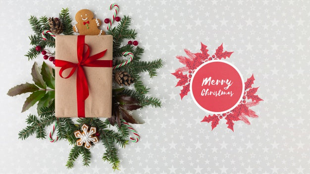Christmas Composition With Green Leaves And Gift Top View Psd