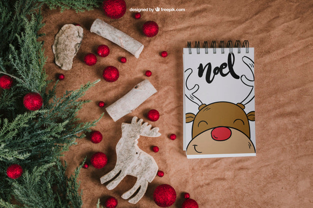 Christmas Mockup With Notepad Next To Balls And Reindeer Psd