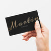 Classy Business Card In Black And Gold In A Hand Psd