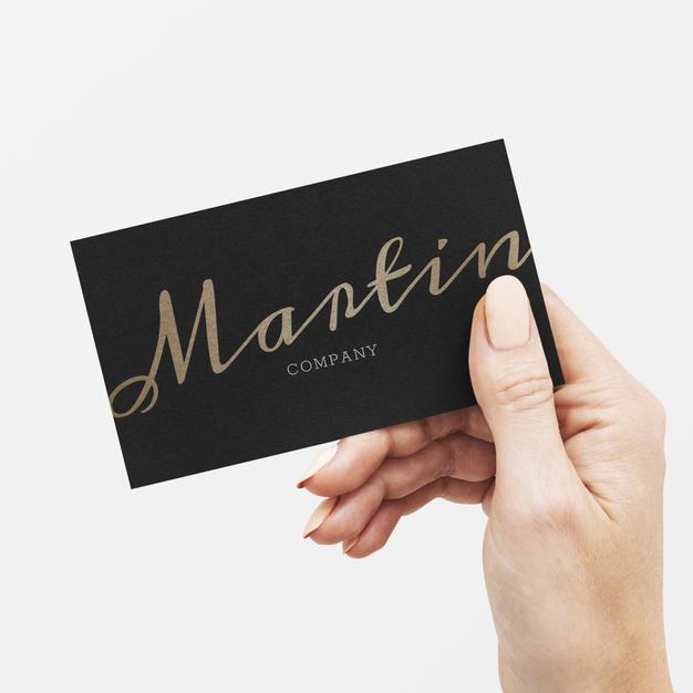 Classy Business Card In Black And Gold In A Hand Psd