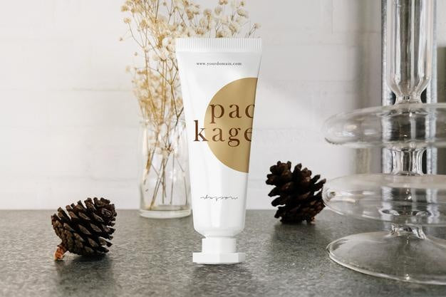 Clean Minimal Cream Tube Packaging Mockup Standing On Grey Marble With Pine Flower Background. Psd File. Psd