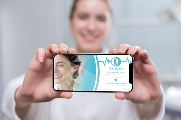 Close-Up Dentist Holding A Smartphone Psd