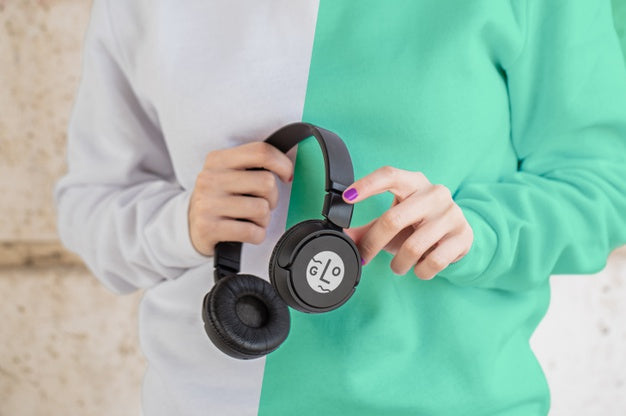 Close-Up Girl With Hoddie Holding Headphones Psd