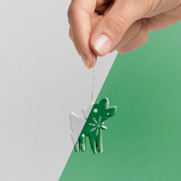 Close-Up Hand Holding Reindeer Decoration Psd