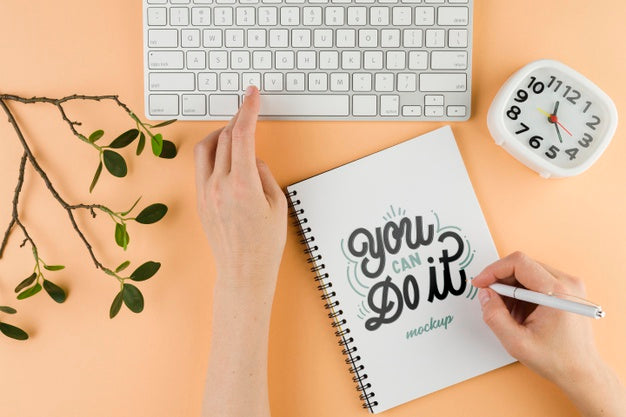 Close-Up Hand Writing On Notebook Psd