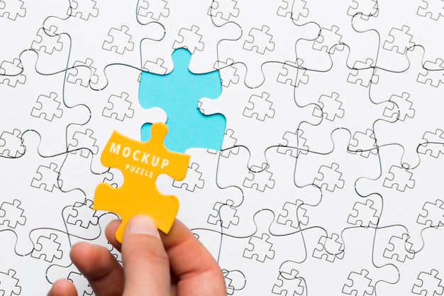 Close-Up Man Holding A Yellow Piece Of Puzzle Psd