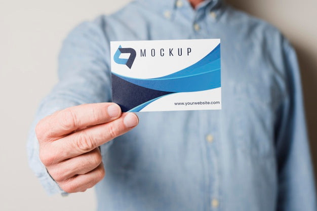 Close-Up Man Holding Business Card Psd