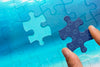 Close-Up Man Holding Jigsaw Piece Of Puzzle Psd