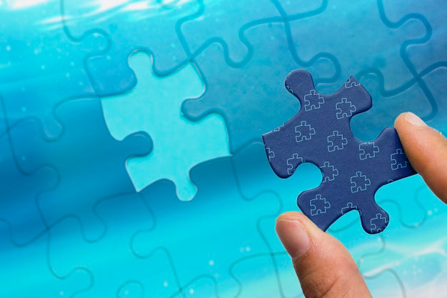 Close-Up Man Holding Jigsaw Piece Of Puzzle Psd
