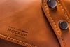 Close-Up Of Brown Leather With Strap And Buttons Psd