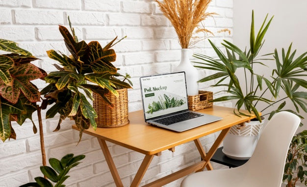 Close Up On Computer Mockup Surrounded By Plants Psd