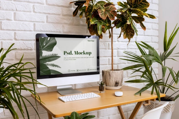 Close Up On Computer Mockup Surrounded By Plants Psd