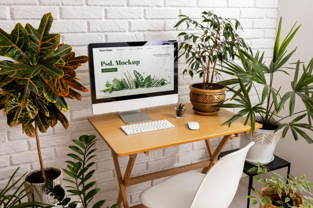 Close Up On Computer Mockup Surrounded By Plants Psd