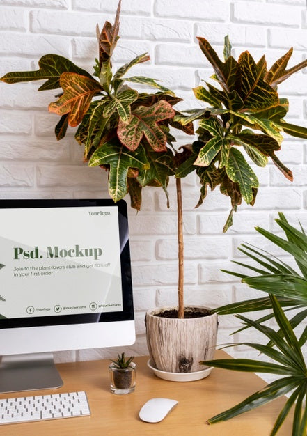 Close Up On Computer Mockup Surrounded By Plants Psd