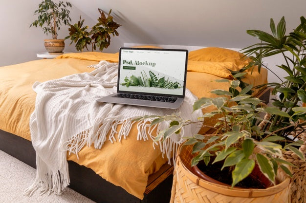 Close Up On Computer Mockup Surrounded By Plants Psd