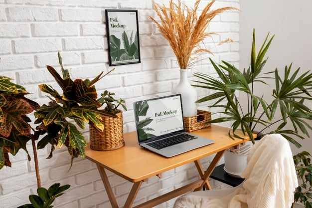 Close Up On Computer Mockup Surrounded By Plants Psd