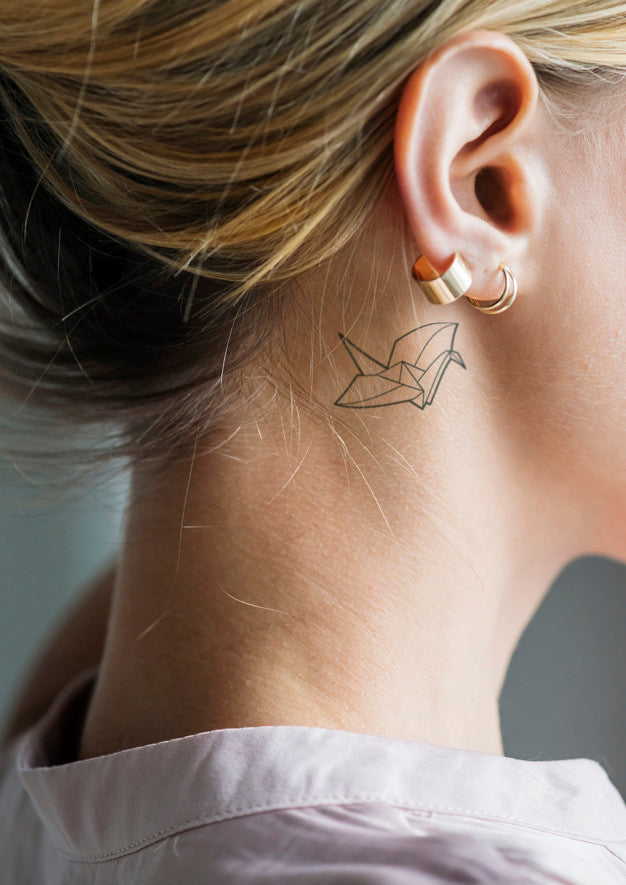 Closeup Of A Simple Behind The Ear Tattoo Of A Young Woman Psd
