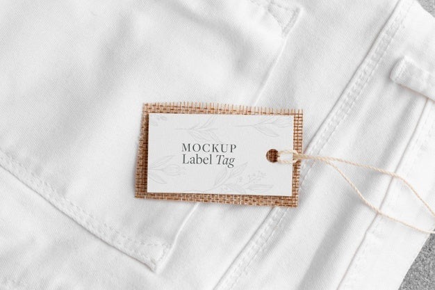 Top View Of Clothing Label On White Shirt Fabric Psd - Mockup Hunt