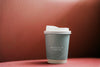 Coffee Cup Mockup In A Red Backdrop Psd
