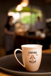 Coffee Cup On Plate With Blurry Background Psd
