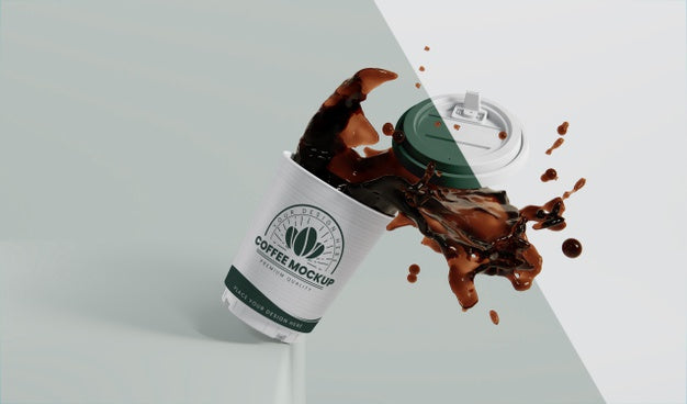 Composition Of Paper Coffee Cup With Coffee Splash Psd