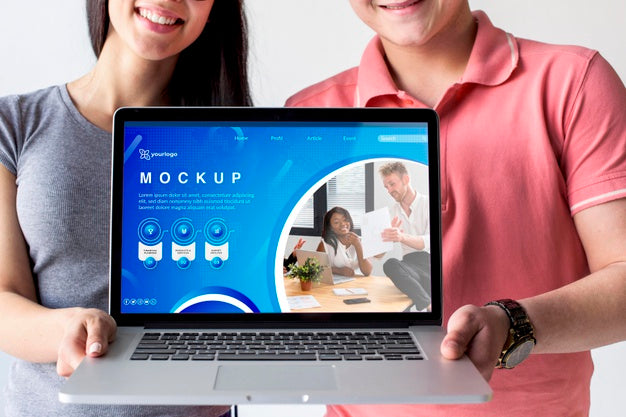Couple Holding A Mock-Up Laptop Psd