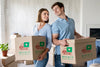 Couple Holding Boxes For Their New Home And Looking At Each Other Psd