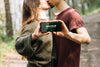 Cute Couple In Nature With Smartphone Mock-Up Psd