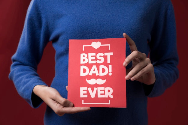 Daughter Holding Cardboard Mock-Up On Burgundy Background Psd