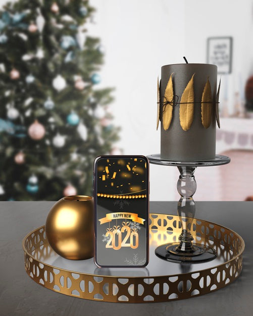Decorations On Tray Beside Phone With Message For New Year Psd