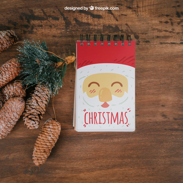 Decorative Christmas Mockup With Notepad And Pine Cones Psd