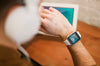 Defocused Man Working From Home While Looking At Smartwatch Psd