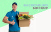 Delivery Man Holding A Box Full Of Vegetables With Background Mock-Up Psd
