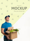 Delivery Man Holding A Box With Different Vegetables Psd
