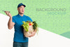 Delivery Man Holding A Box With Different Vegetables With Background Mock-Up Psd