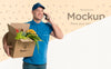 Delivery Man Holding A Box With Vegetables Psd