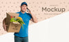Delivery Man Holding A Box With Vegetables While Talking On The Phone Psd