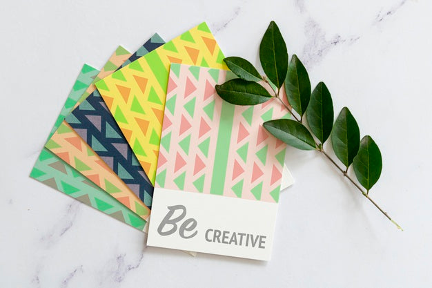 Desk With Stack Of Agenda And Leaves Beside Psd