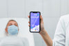 Doctor With Face Mask Holding Phone Mock-Up Near Patient Psd