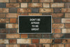 Don' Be Afraid To Be Great Board Mockup On A Brick Wall Psd