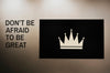 Don'T Be Afraid To Be Great Quoted On A Wall Next To A Crown Board Mockup Psd