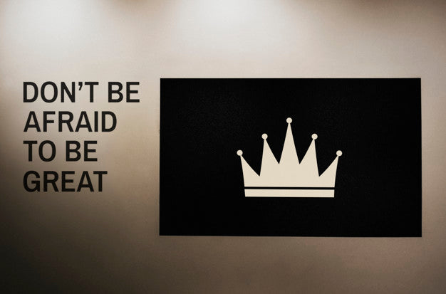 Don'T Be Afraid To Be Great Quoted On A Wall Next To A Crown Board Mockup Psd