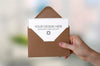 Enveloped Paper Holded By Hand Mockup Psd