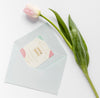Fat Lay Of Wedding Card With Envelope And Tulip Psd