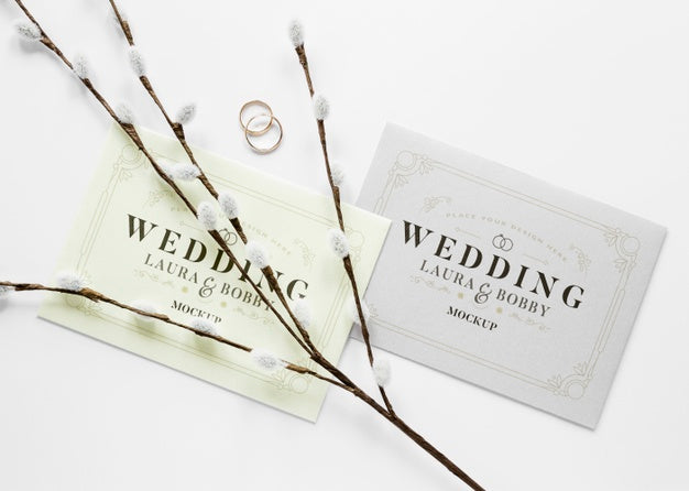 Fat Lay Of Wedding Cards With Rings And Flowers Psd