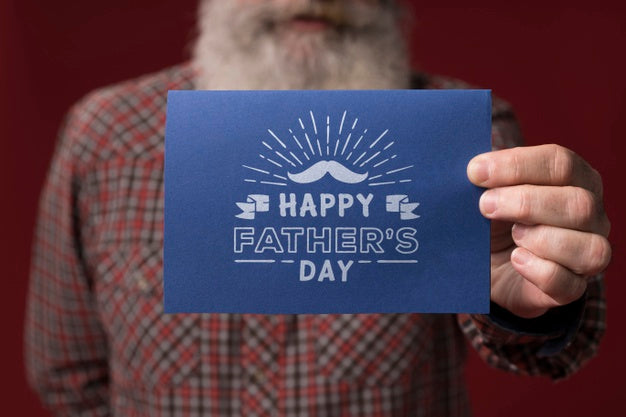 Father Holding Cardboard Mock-Up On Burgundy Background Psd