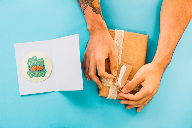 Fathers Day Mockup With Card And Hands Preparing Present Box Psd