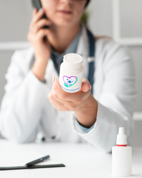 Female Doctor Holding A Mock-Up Medicine Bottle Psd