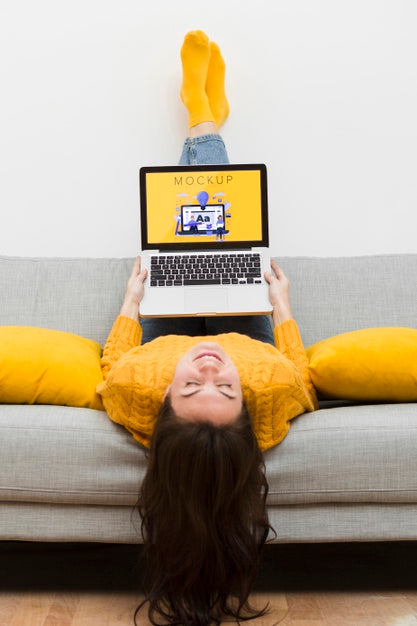 Female On Couch Working On Laptop Psd