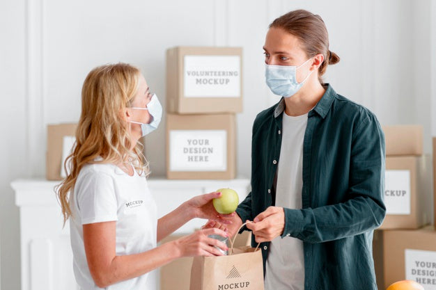 Female Volunteer With Medical Mask Handing Out Food Donation To Man Psd